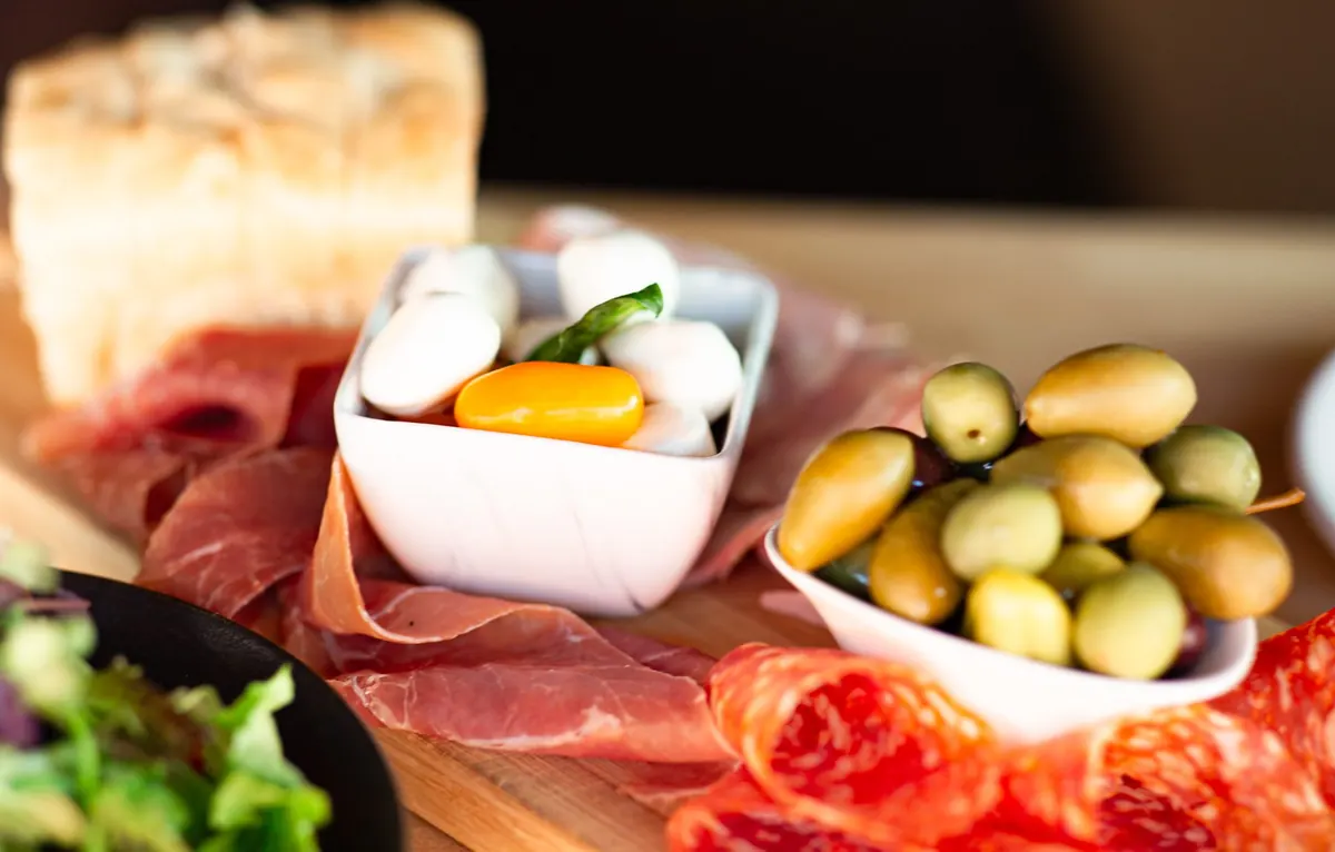 Antipasto board with cured meats, mozzarella and olives photographed for SLATE's dinner page